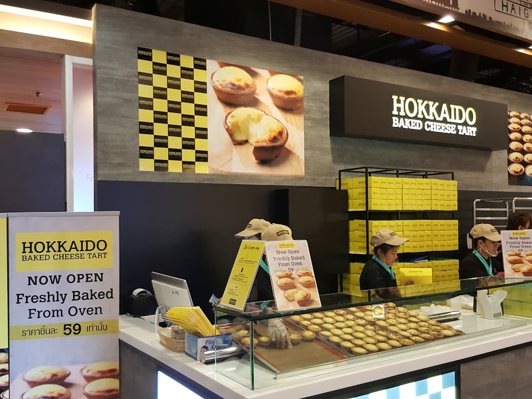 Interior view of Hokkaido Baked Cheese Tart, showcasing freshly baked tarts and staff.