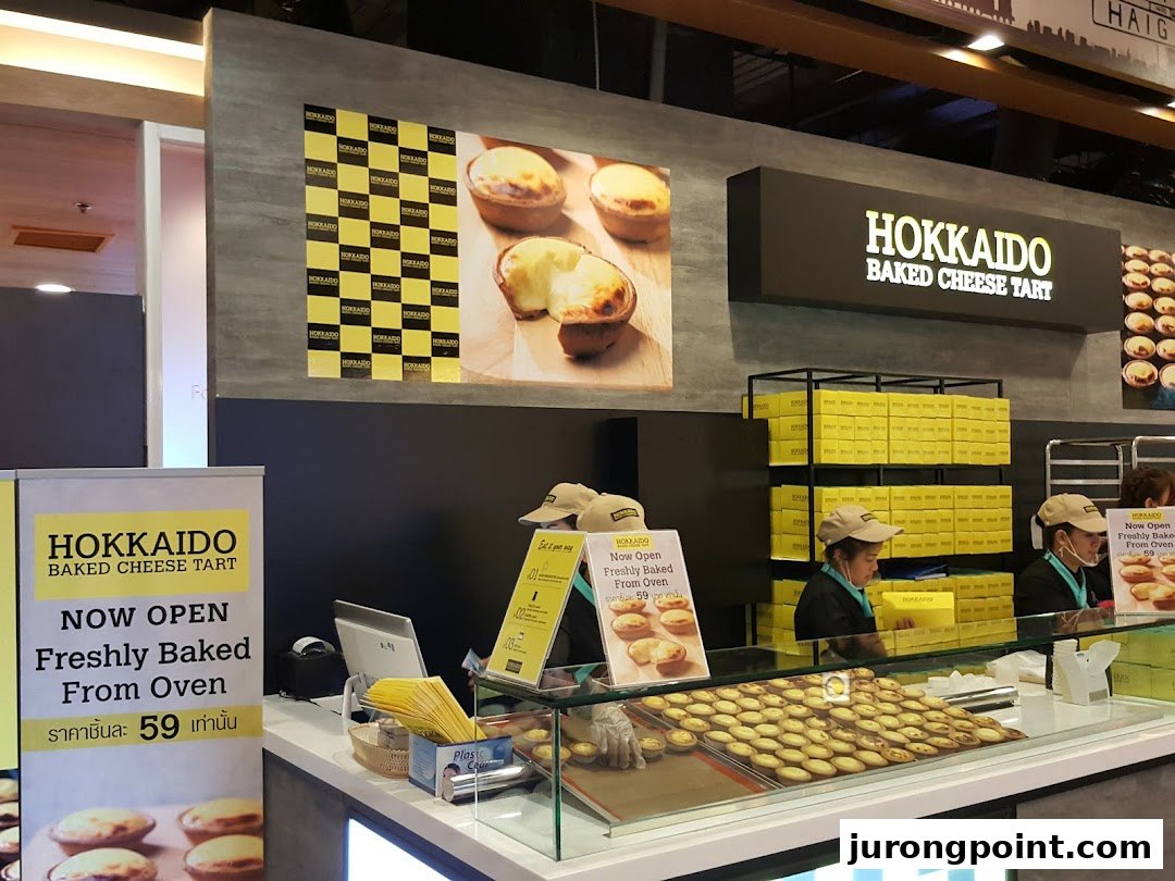 Interior view of Hokkaido Baked Cheese Tart, showcasing freshly baked tarts and staff.