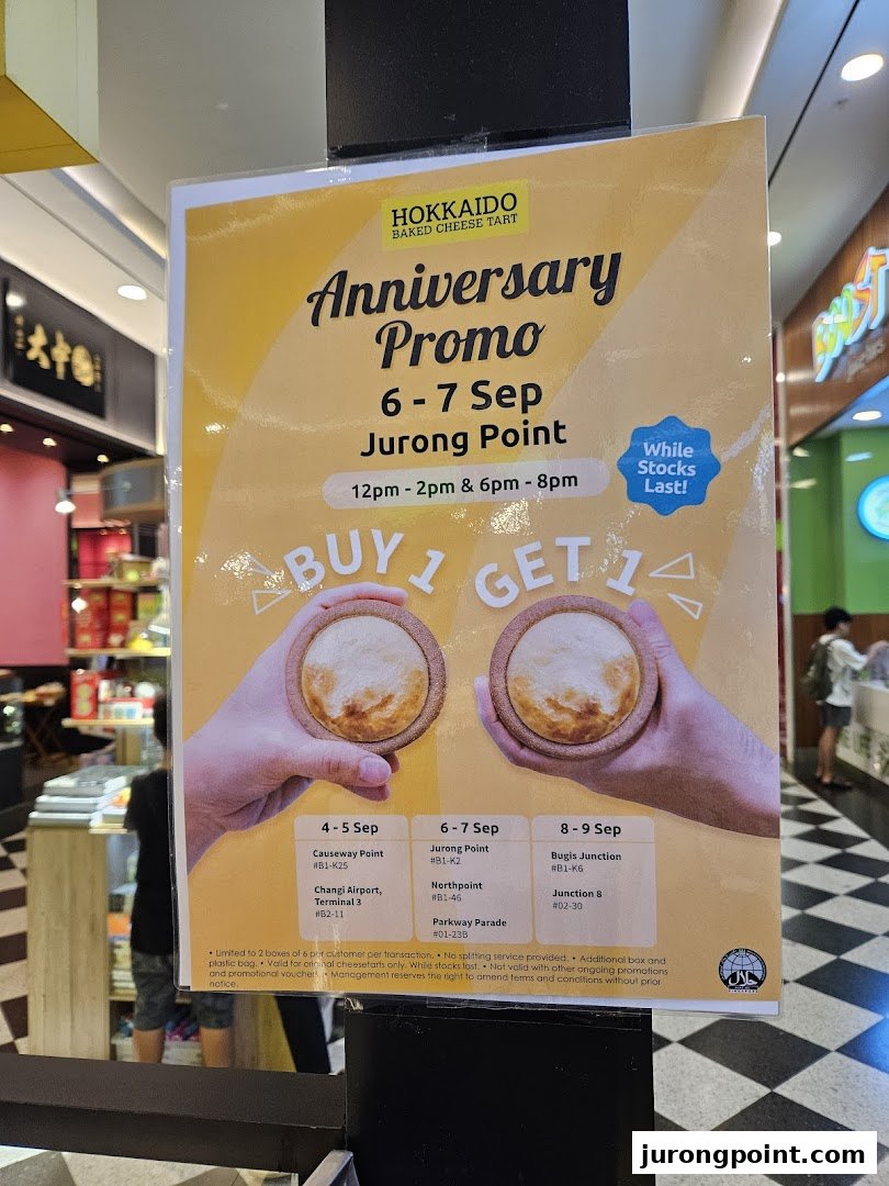 A promotional poster for Hokkaido Baked Cheese Tart's anniversary 'Buy 1 Get 1' offer on cheese tarts.