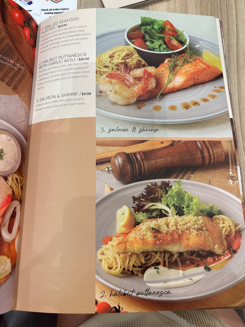 A page from Hot Tomato's menu featuring seafood and pasta dishes with prices and descriptions.