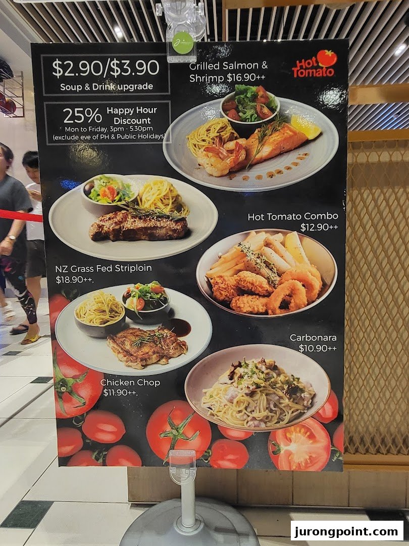 A Hot Tomato restaurant menu board displaying various Western dishes, prices, and promotions.
