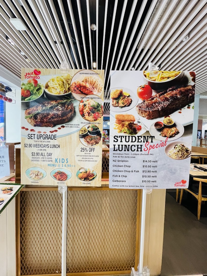 Two large menu boards for Hot Tomato, showcasing various dishes, prices, and lunch specials.