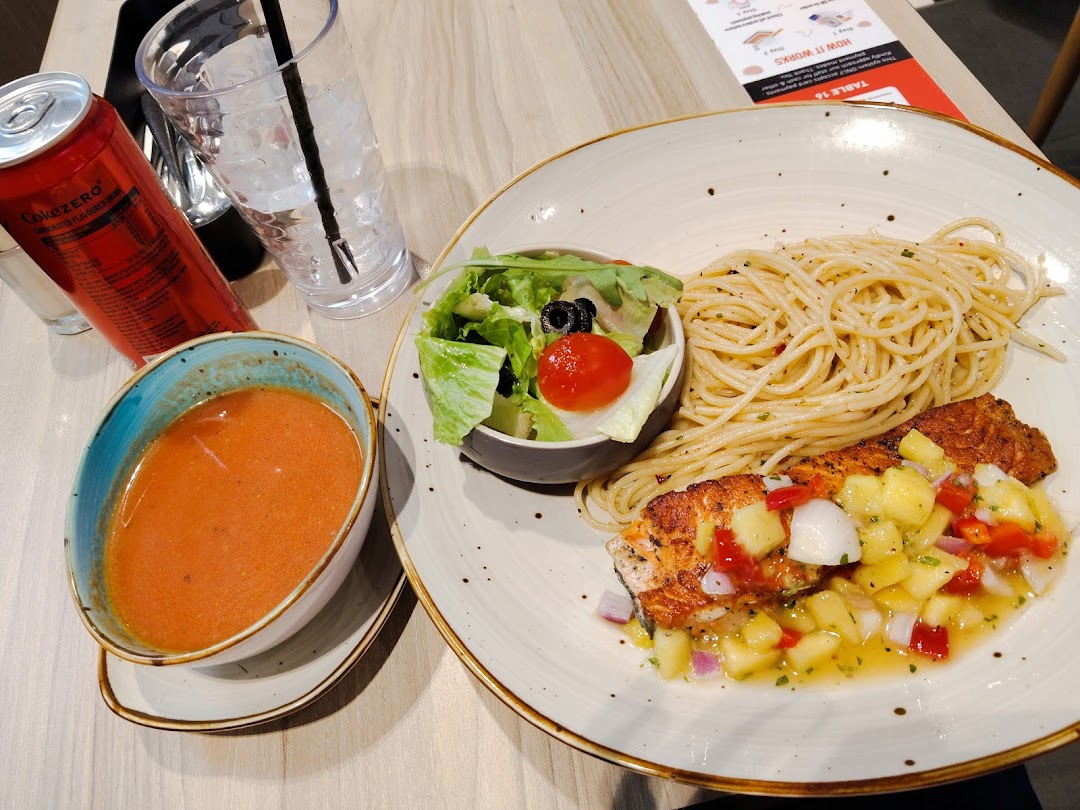 A delicious meal featuring salmon with salsa, spaghetti, fresh salad, and a side of soup.