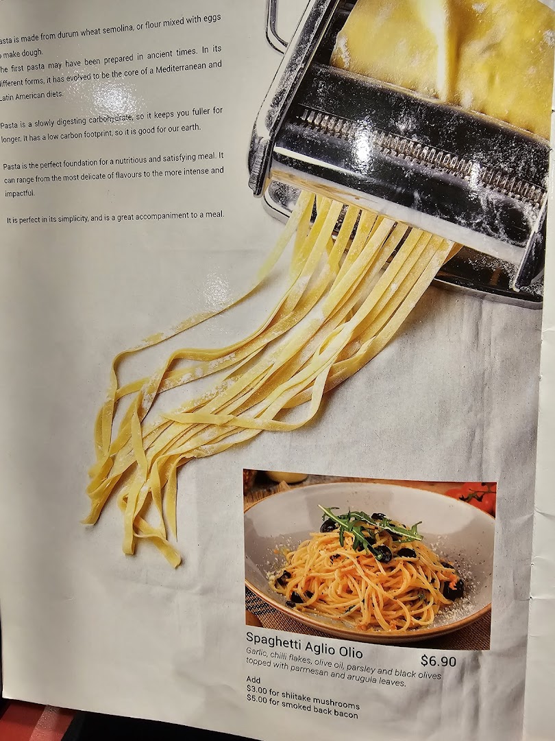 A menu page featuring fresh pasta being made and a listing for Spaghetti Aglio Olio.