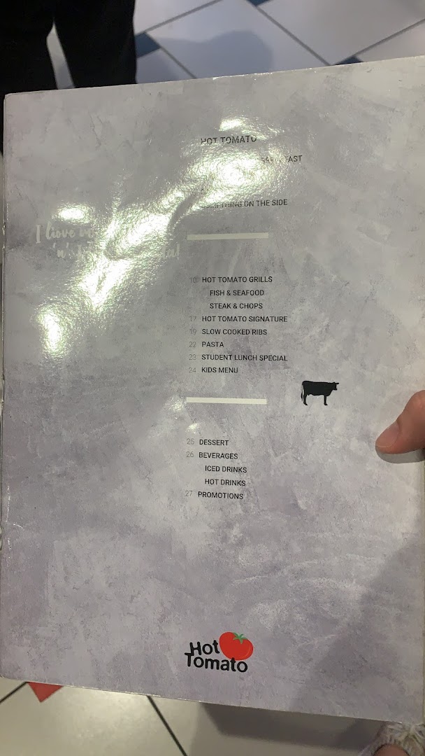 A close-up view of the Hot Tomato restaurant menu, displaying various food and drink categories.