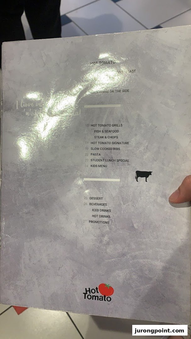 A close-up view of the Hot Tomato restaurant menu, displaying various food and drink categories.