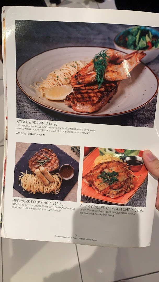 A menu page from Hot Tomato showcasing steak, prawn, pork chop, and chicken chop dishes.