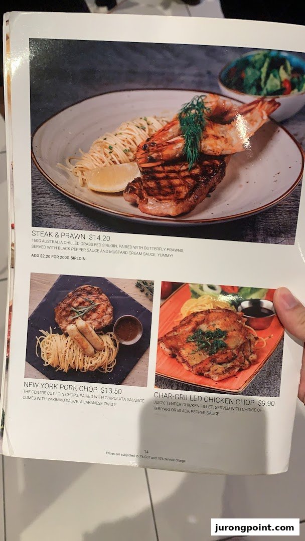 A menu page from Hot Tomato showcasing steak, prawn, pork chop, and chicken chop dishes.