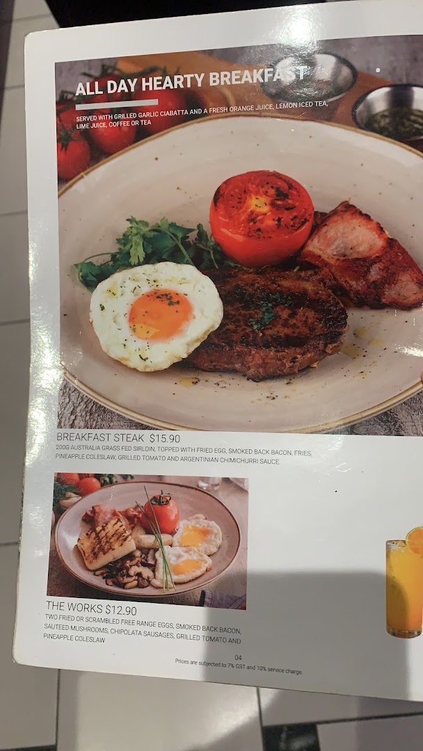 A menu page from Hot Tomato showcasing hearty breakfast options with detailed descriptions and prices.