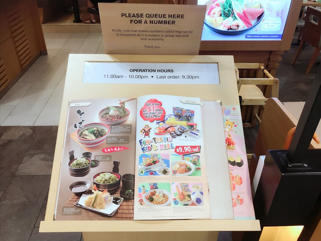 A stand at Ichiban Boshi displaying menu items, operating hours, and queuing instructions.