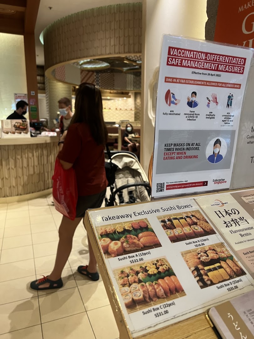 A display board at Ichiban Boshi showcasing takeaway sushi boxes and bento options with prices.