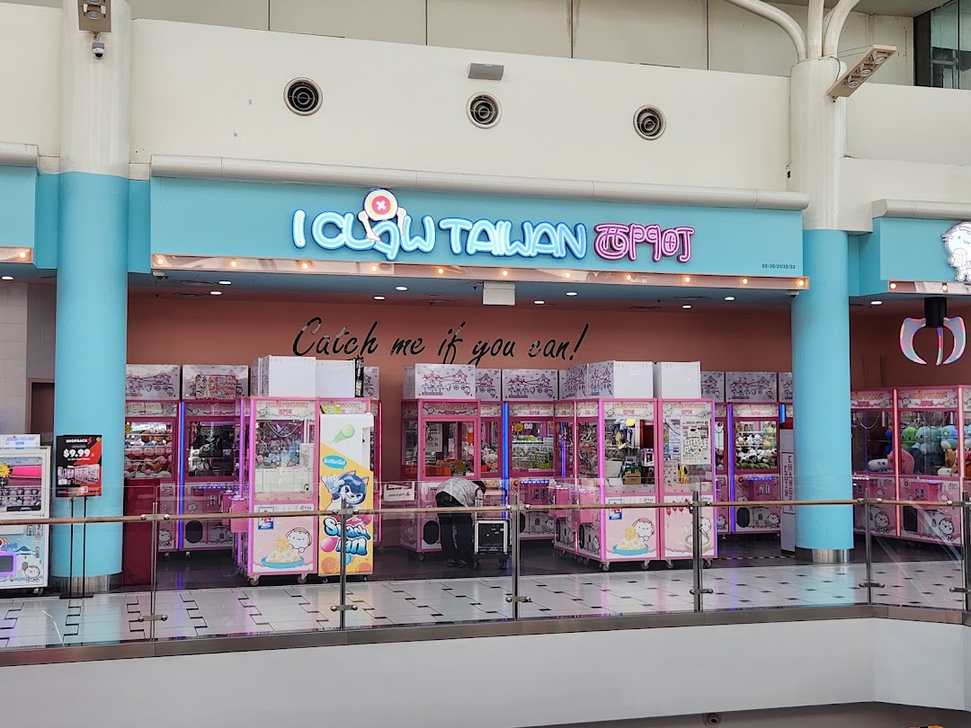 The vibrant entrance of iClaw Taiwan, a claw machine arcade, filled with numerous pink claw machines.