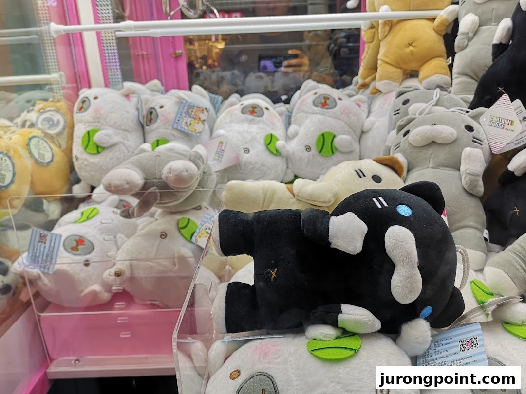 A vibrant claw machine filled with an assortment of cute plush toys, ready for players to win.