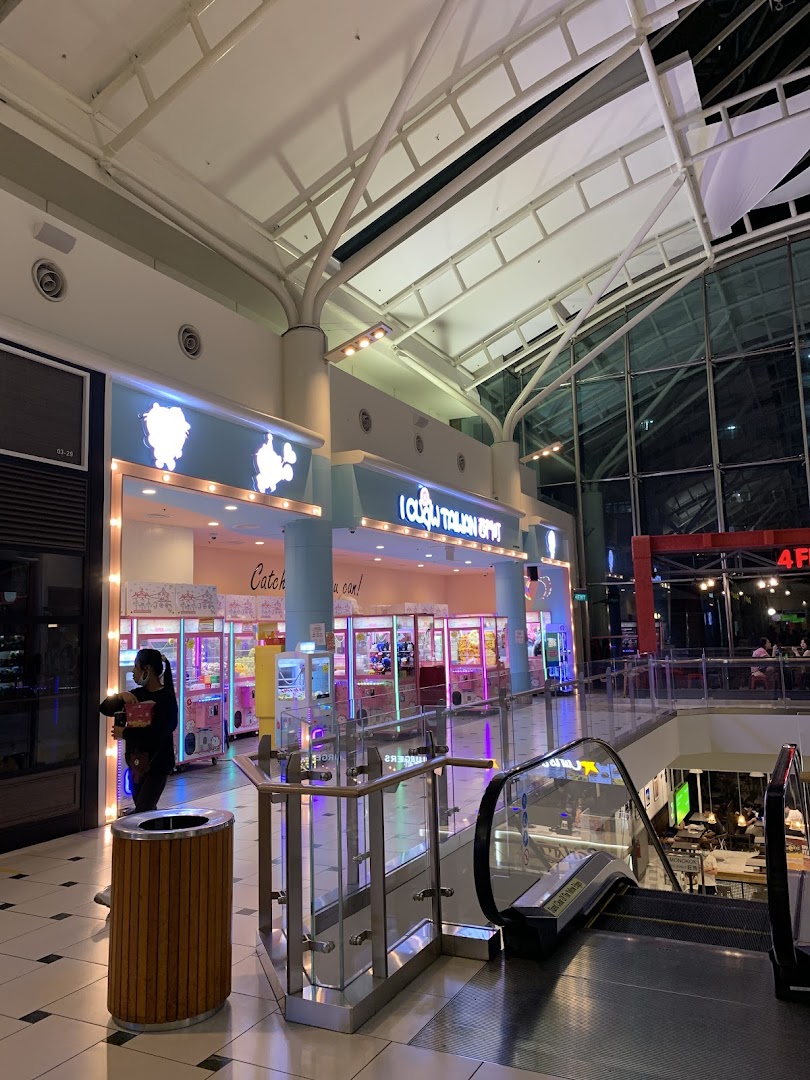 The brightly lit entrance of iClaw Taiwan, a claw machine arcade, within a shopping mall.