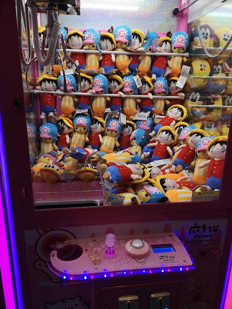 A vibrant claw machine filled with various anime and cartoon character plush toys, ready to be won.