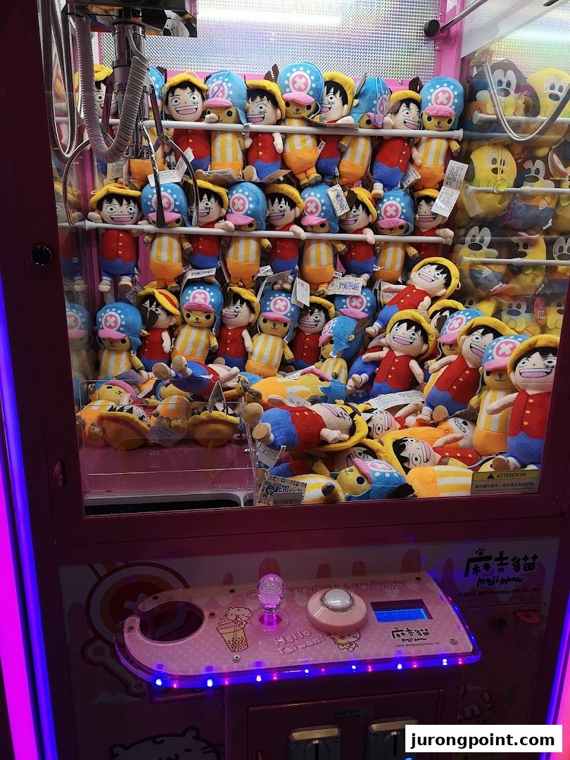 A vibrant claw machine filled with various anime and cartoon character plush toys, ready to be won.