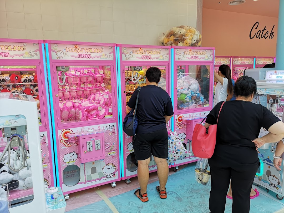 People playing colorful claw machines filled with plush toys at iClaw Taiwan.