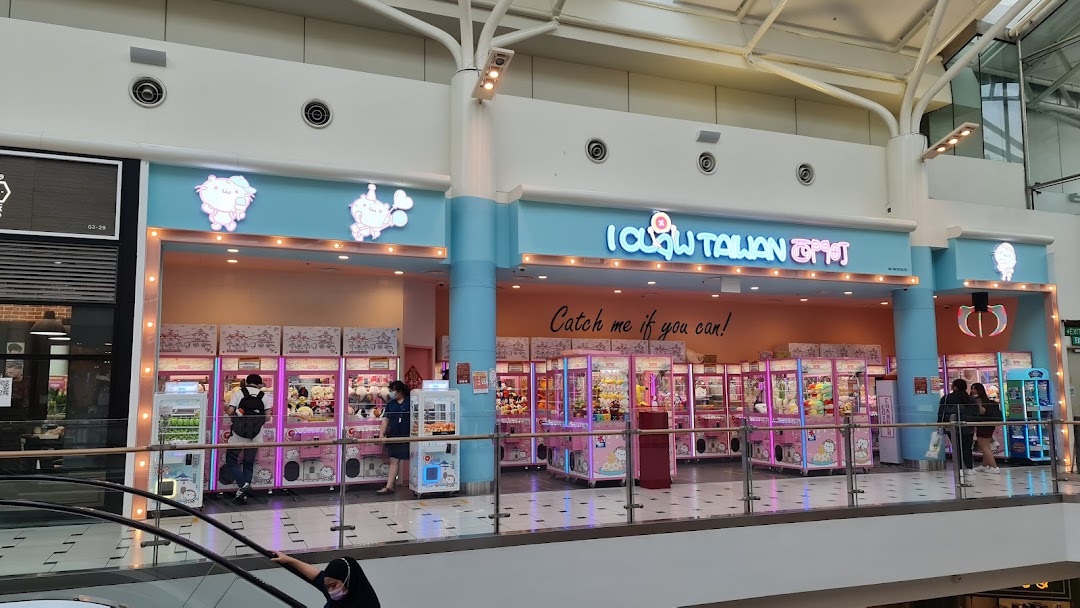 Brightly lit entrance of iClaw Taiwan, featuring numerous claw machines and playful decor.