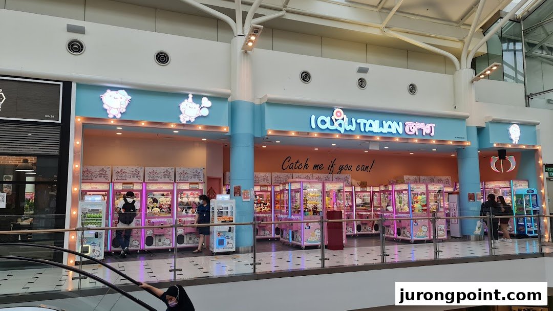 Brightly lit entrance of iClaw Taiwan, featuring numerous claw machines and playful decor.