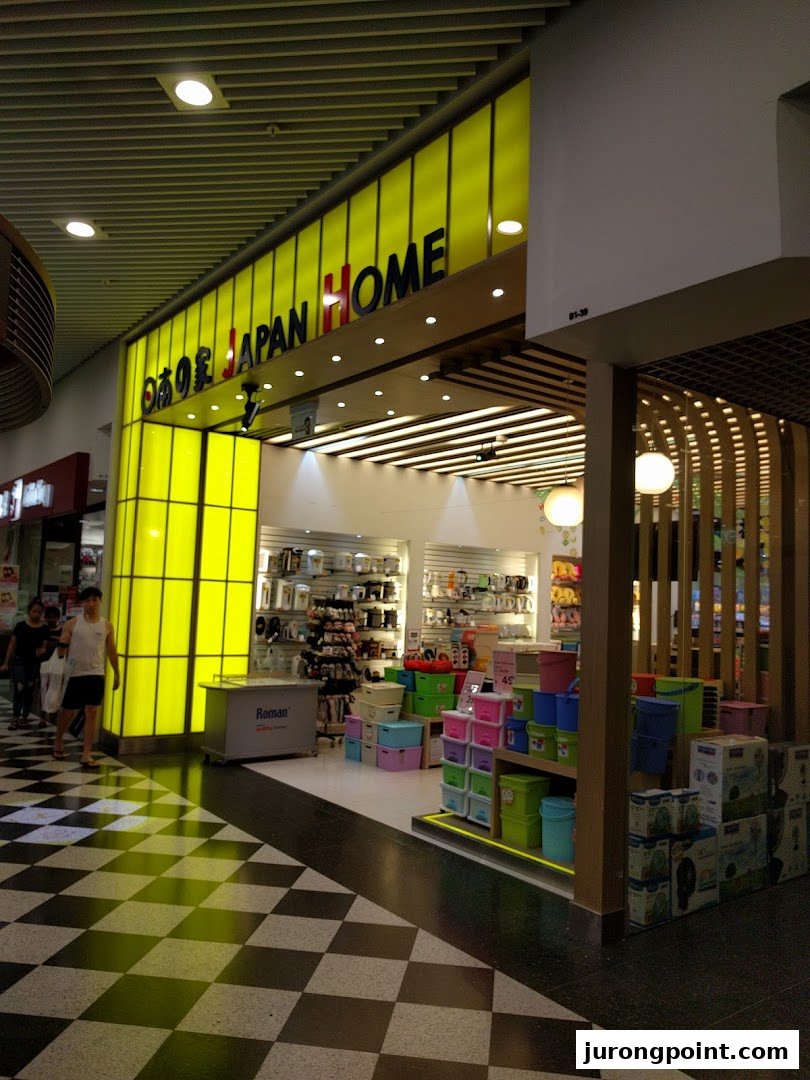 The bright yellow storefront of Japan Home, showcasing its wide array of household and daily essential products.
