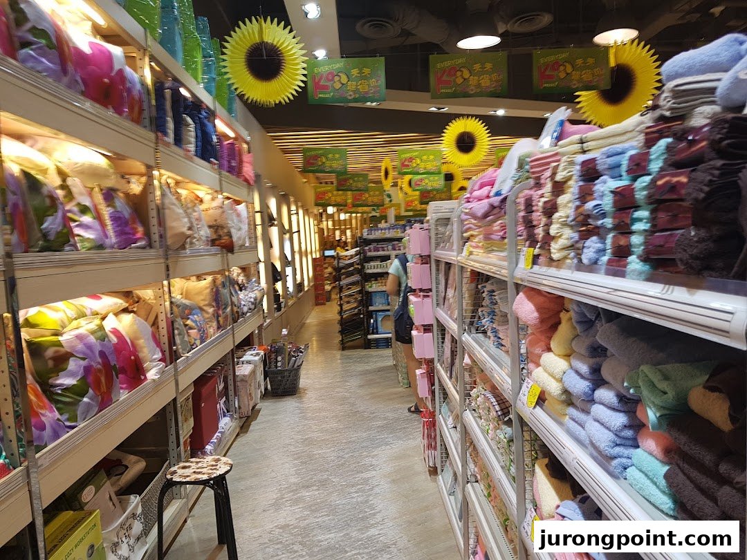 An interior view of Japan Home, showcasing aisles filled with home goods like pillows and towels.