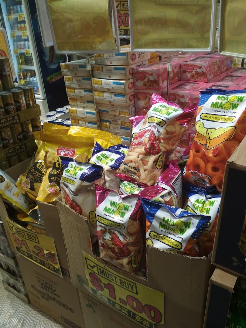 A retail display featuring various packaged snacks like chips and crackers, with prominent price signs.