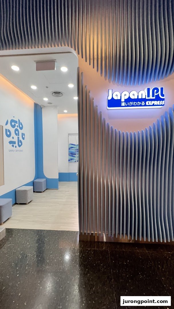 The entrance of Japan IPL Express features a modern blue and white design with a distinctive wavy facade.
