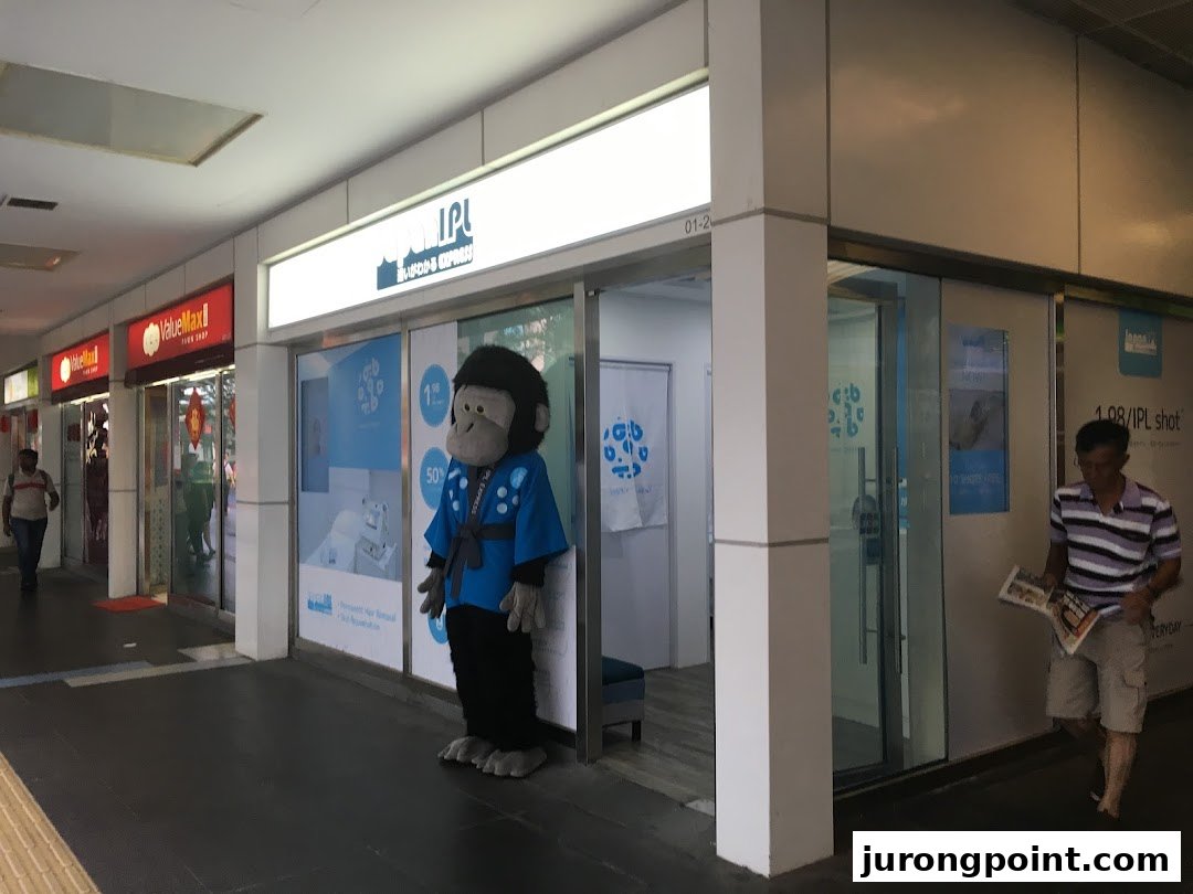 Exterior view of Japan IPL Express shop with a gorilla mascot and prominent signage in a mall corridor.