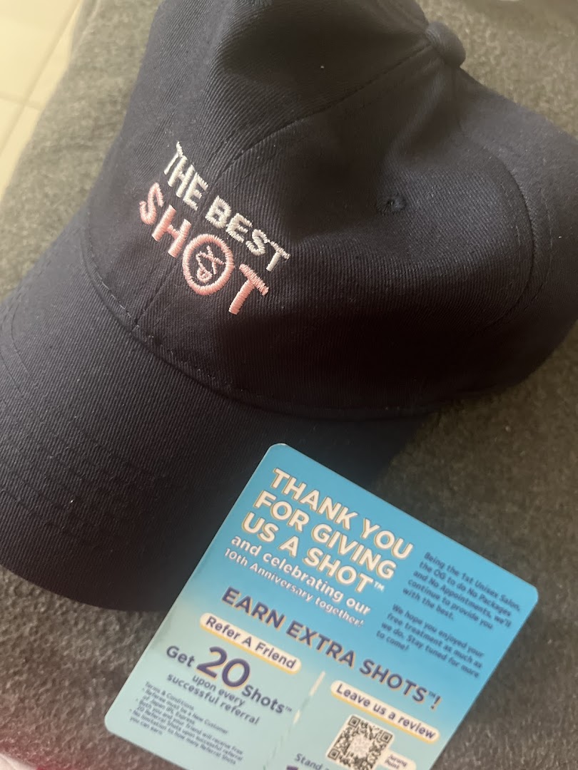 A dark blue cap with 'THE BEST SHOT' embroidery and a Japan IPL Express promotional card.