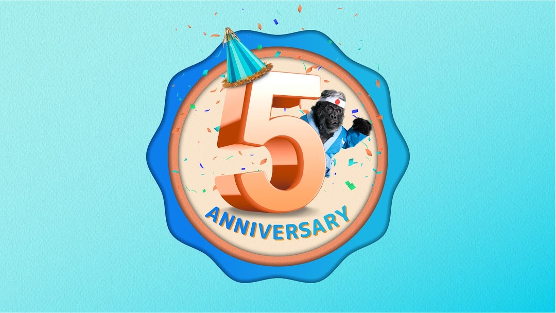 A vibrant graphic celebrating 5th anniversary with a gorilla mascot, confetti, and a party hat.