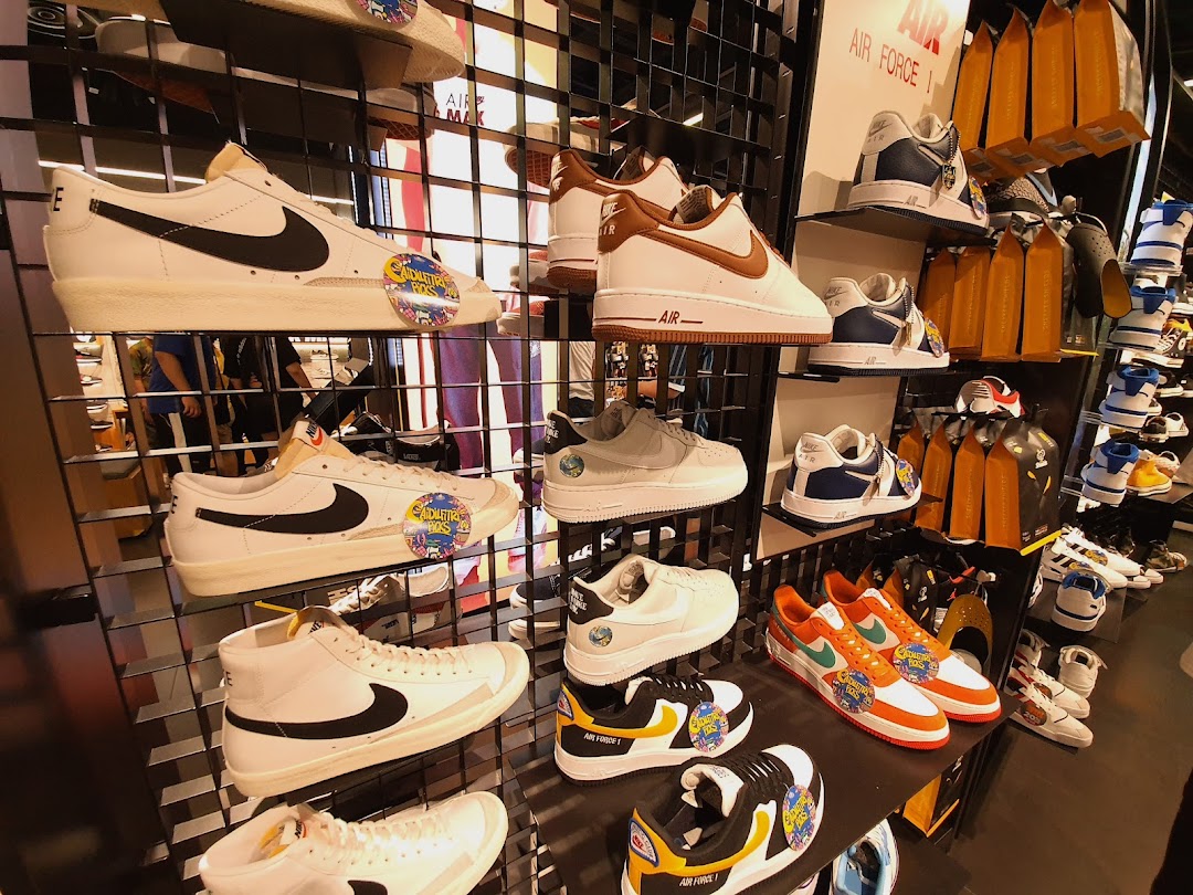 A vibrant display of Nike sneakers, including Air Force 1s and Blazers, showcased on shelves in a retail store.