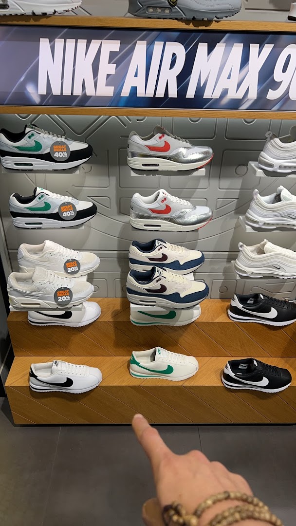 A vibrant display of Nike sneakers, including Air Max models, with some featuring 'Great Deals' discounts.