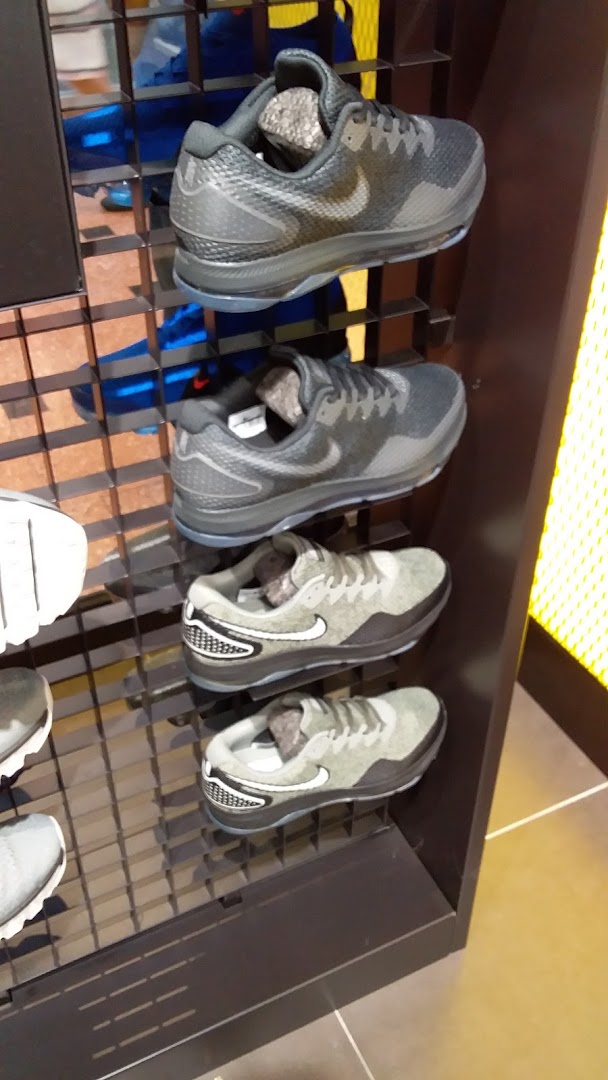 A display of various Nike athletic shoes on shelves inside JD Sports.