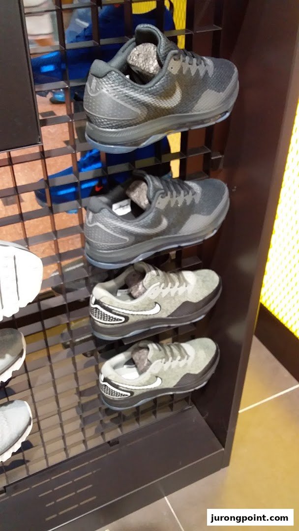 A display of various Nike athletic shoes on shelves inside JD Sports.