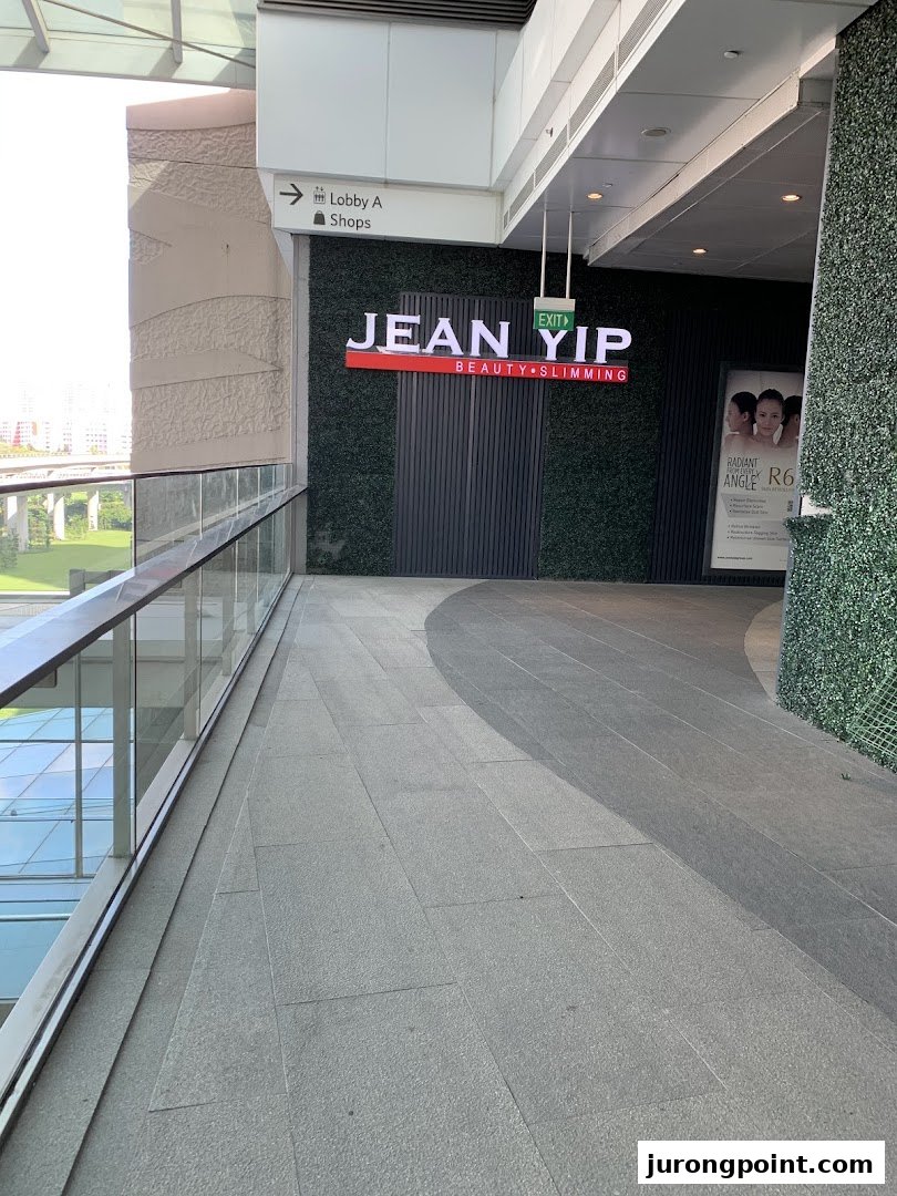 Exterior view of Jean Yip Beauty & Slimming shop entrance with a distinctive green wall facade.
