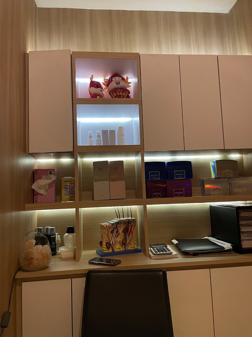 A well-organized shelf unit displaying skincare products, decorative items, and a detailed skin model in a treatment room.