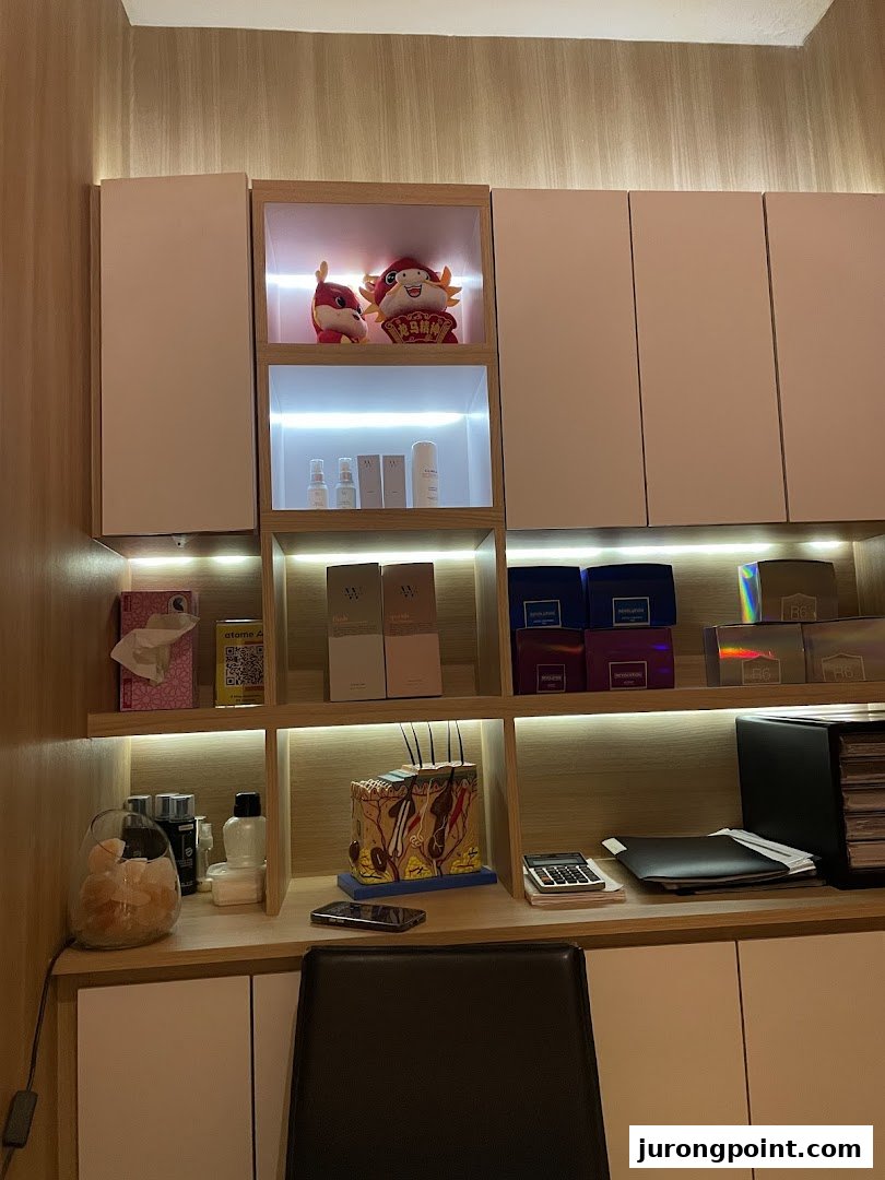 A well-organized shelf unit displaying skincare products, decorative items, and a detailed skin model in a treatment room.