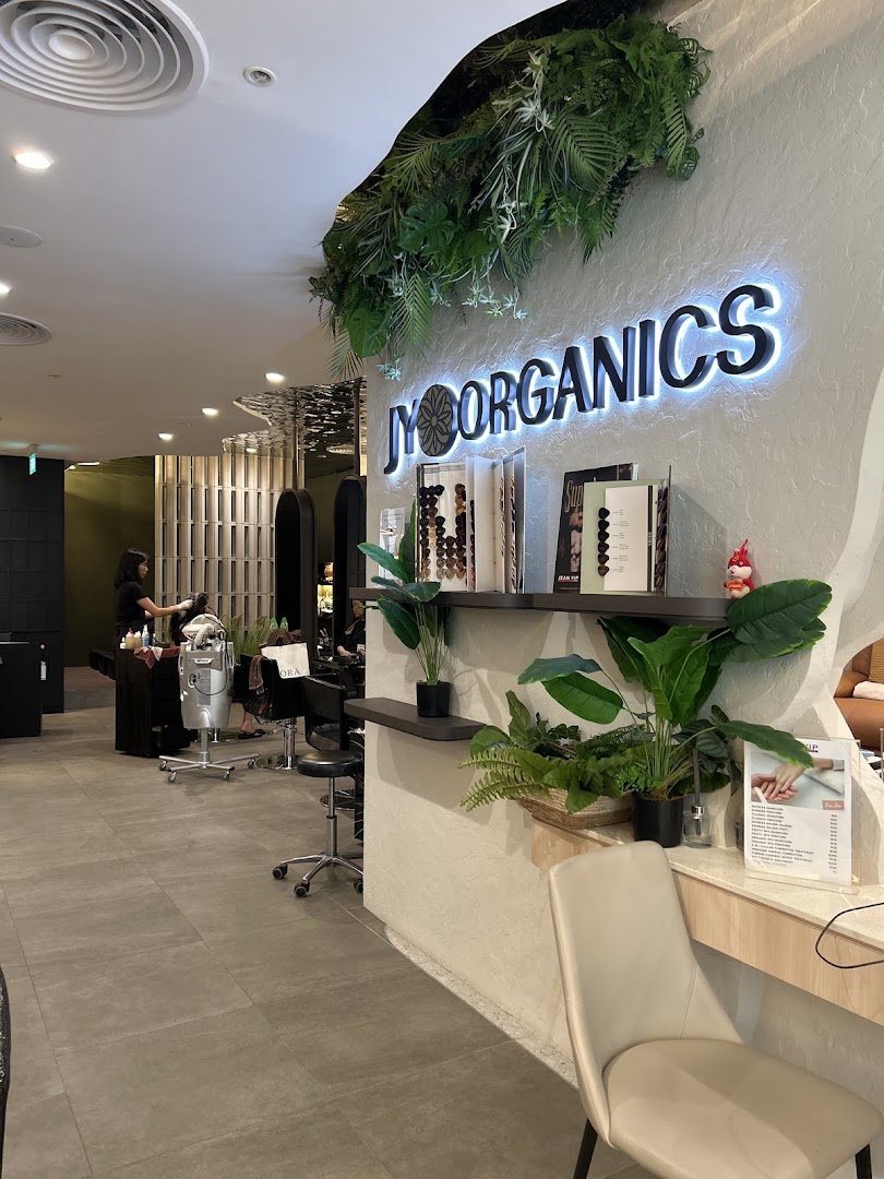 Interior view of Jean Yip Hairdressing salon, showcasing styling stations and the 'JY Organics' section.