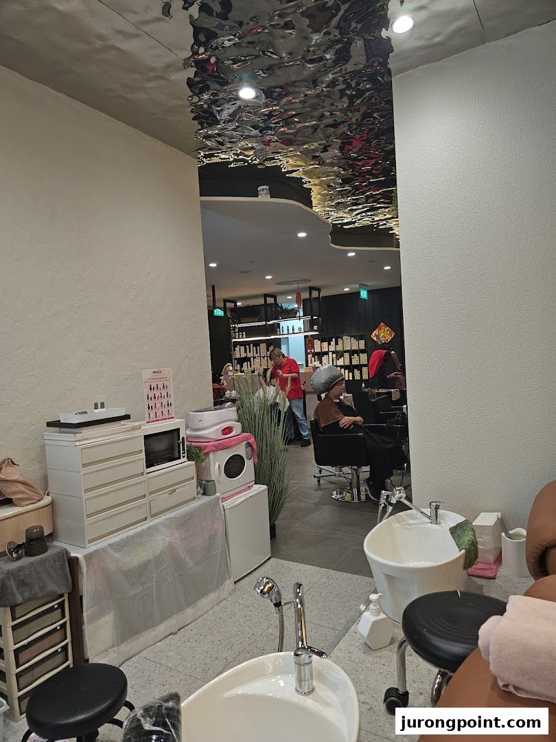 Interior view of Jean Yip Hairdressing, showing styling stations, a pedicure area, and clients.