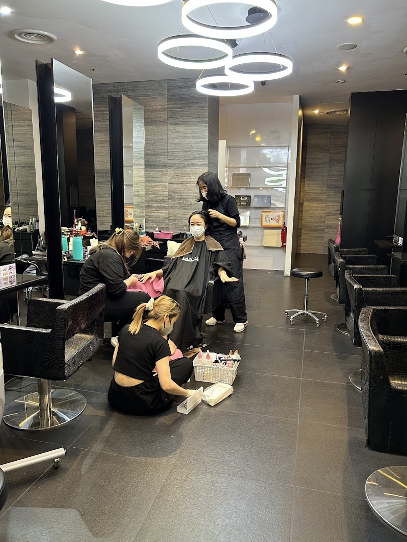Interior view of Jean Yip Hairdressing salon with customers receiving hair and beauty services.