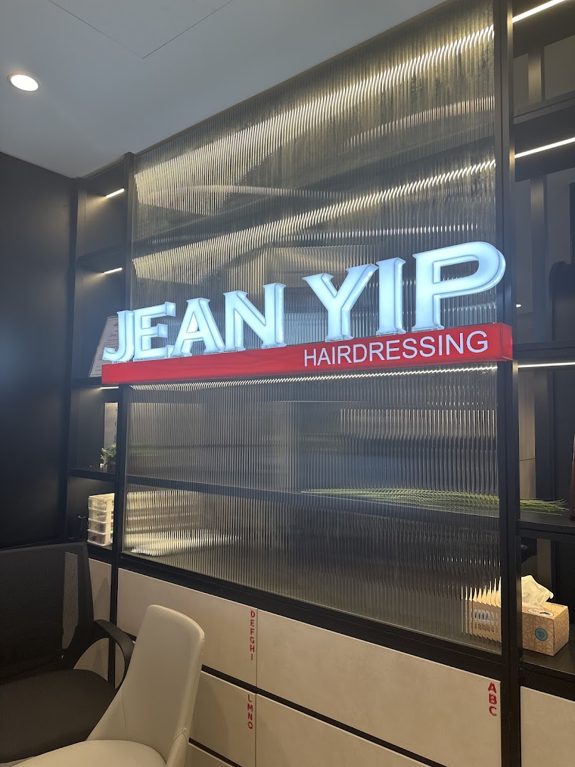 An interior shot of Jean Yip Hairdressing featuring its illuminated sign and modern waiting area.