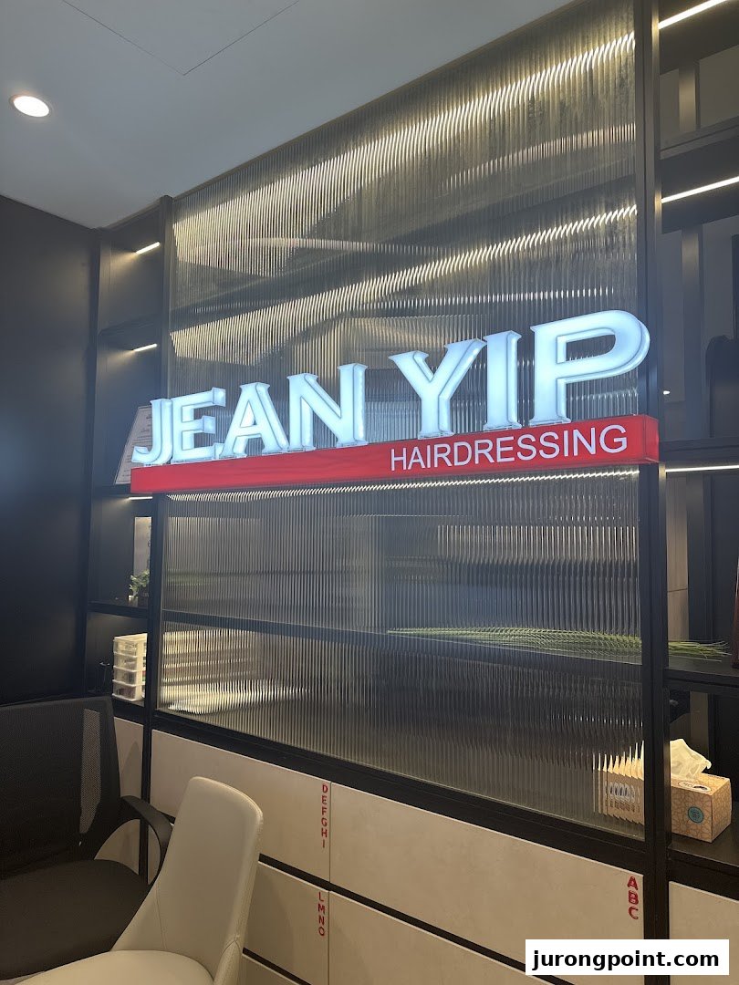 An interior shot of Jean Yip Hairdressing featuring its illuminated sign and modern waiting area.