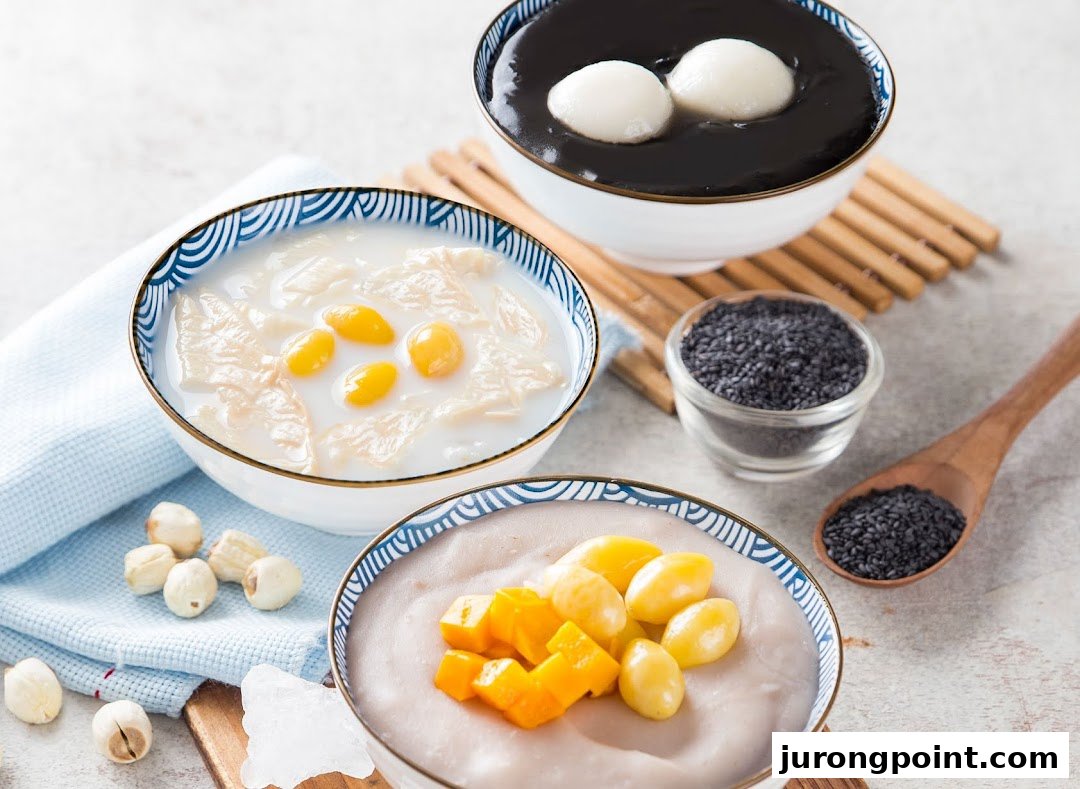 Three bowls of traditional Asian desserts, including black sesame soup, ginkgo nut, and taro/yam puddings.