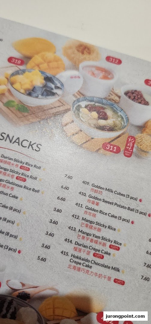 A close-up view of Ji De Chi Dessert's menu, showcasing various snacks and desserts with prices.