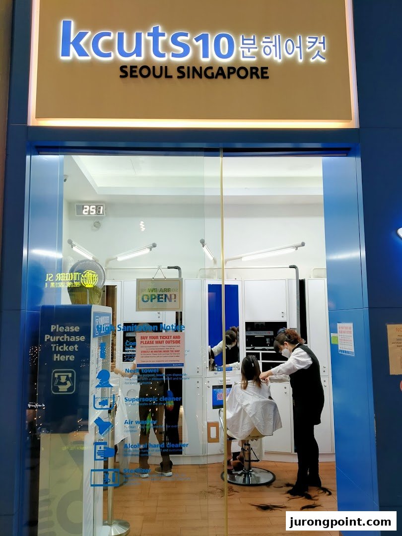 The kcuts shopfront shows a stylist cutting hair inside, highlighting its quick service.