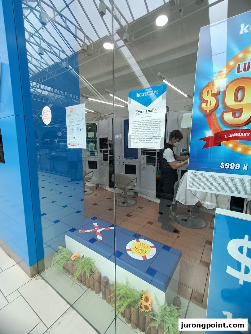 The kcuts shop entrance features a staff member inside, visible through the glass facade.