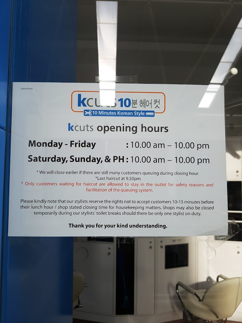 A sign displaying kcuts' opening hours and service policies at the shop entrance.