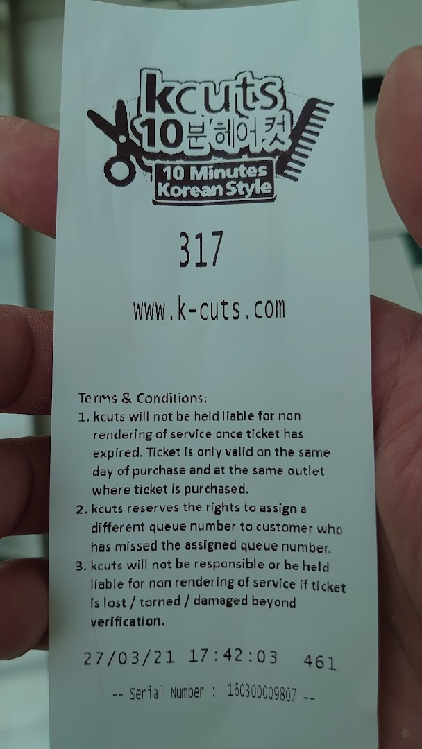 A kcuts queue ticket displaying the shop's logo, website, and service terms and conditions.