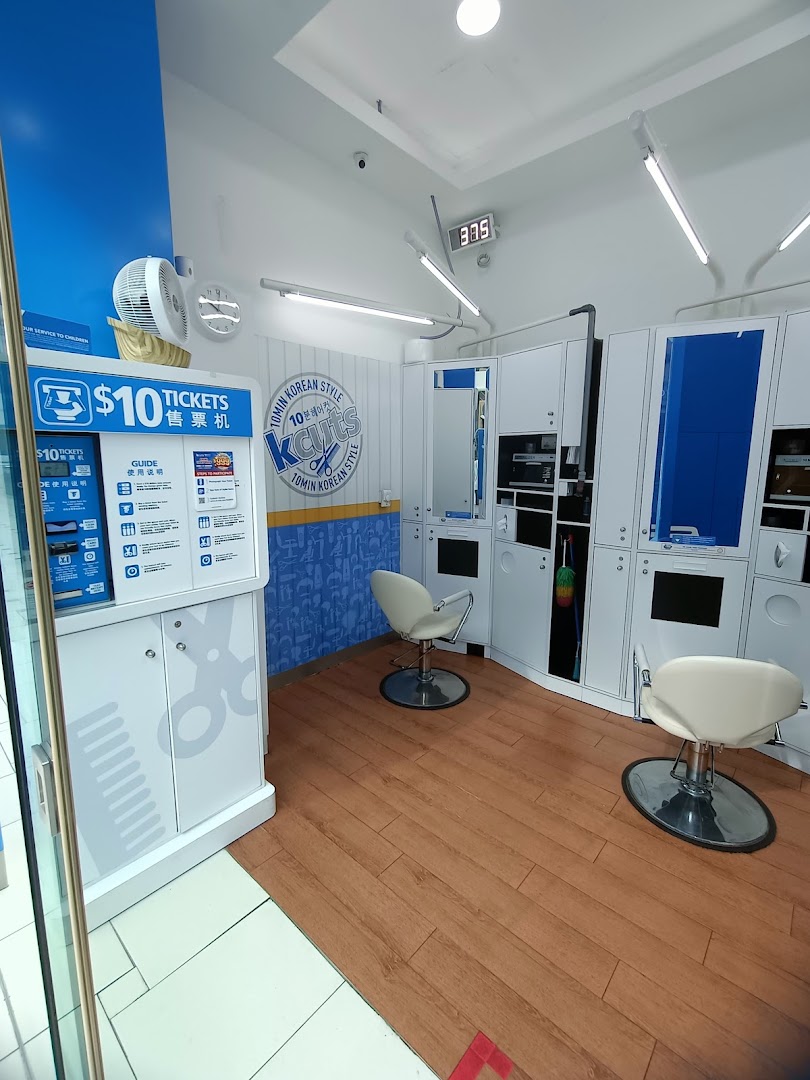 Interior view of kcuts, featuring a ticket machine for $10 haircuts and two styling stations.
