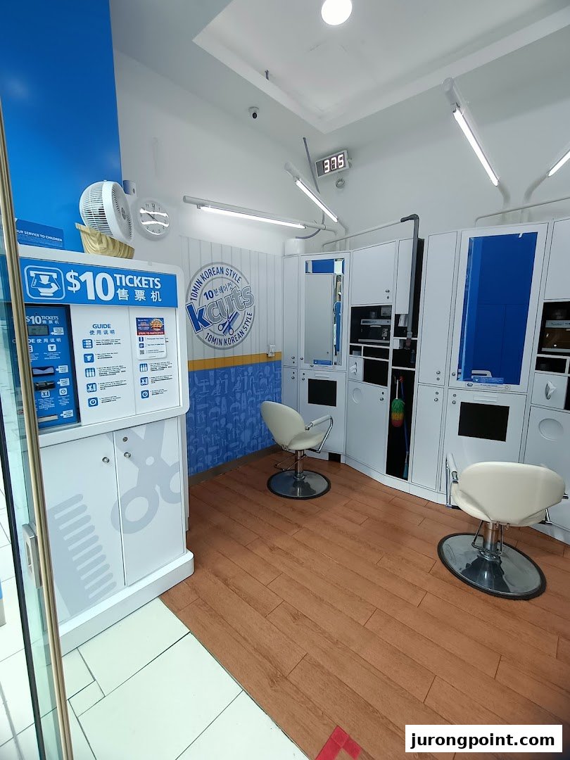 Interior view of kcuts, featuring a ticket machine for $10 haircuts and two styling stations.